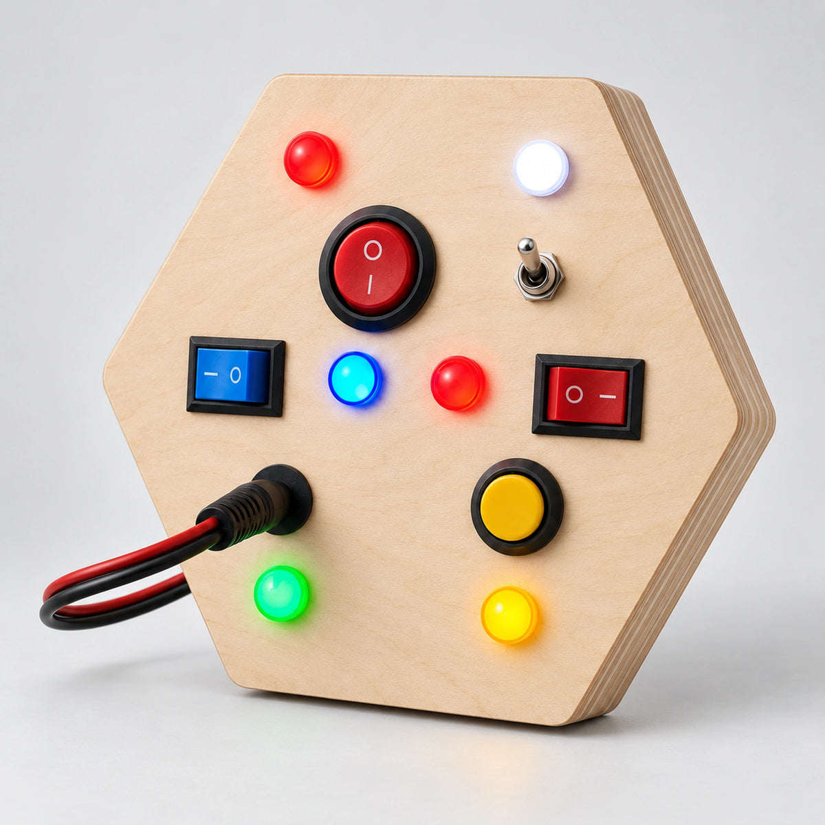 Angled view of RedMonkys Honeycomb Explorer hexagon busy board showing birch wood layers, switches and LED lights