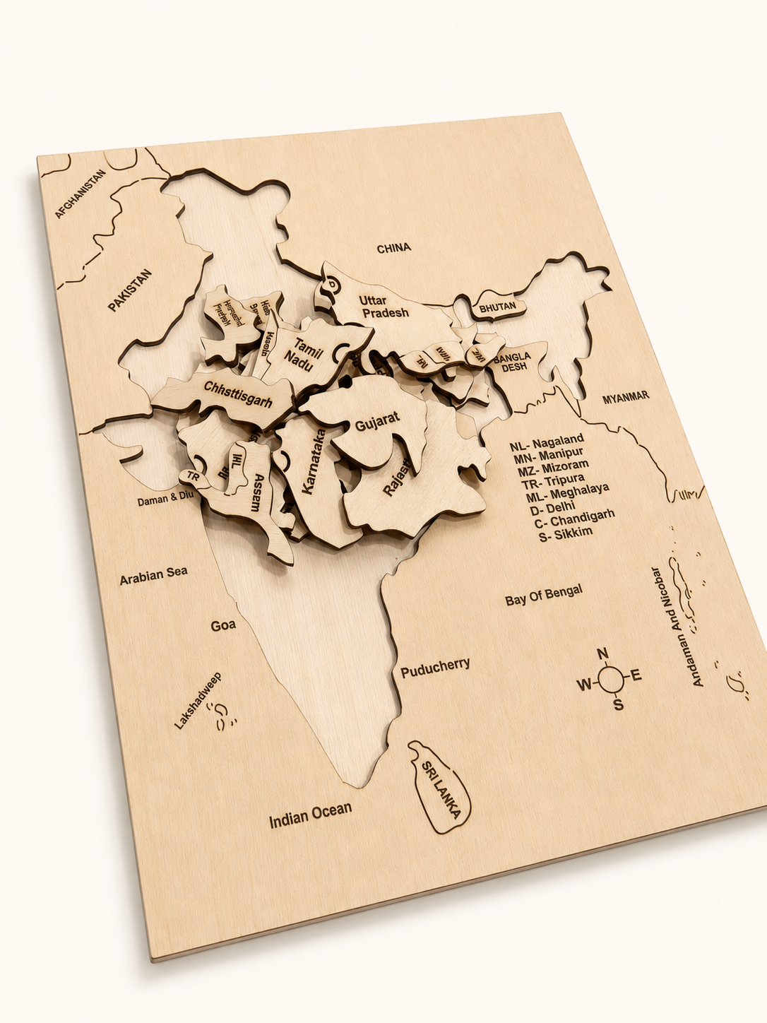 Angled view of RedMonkys Map of India Puzzle showing birch board tray and engraved wooden pieces