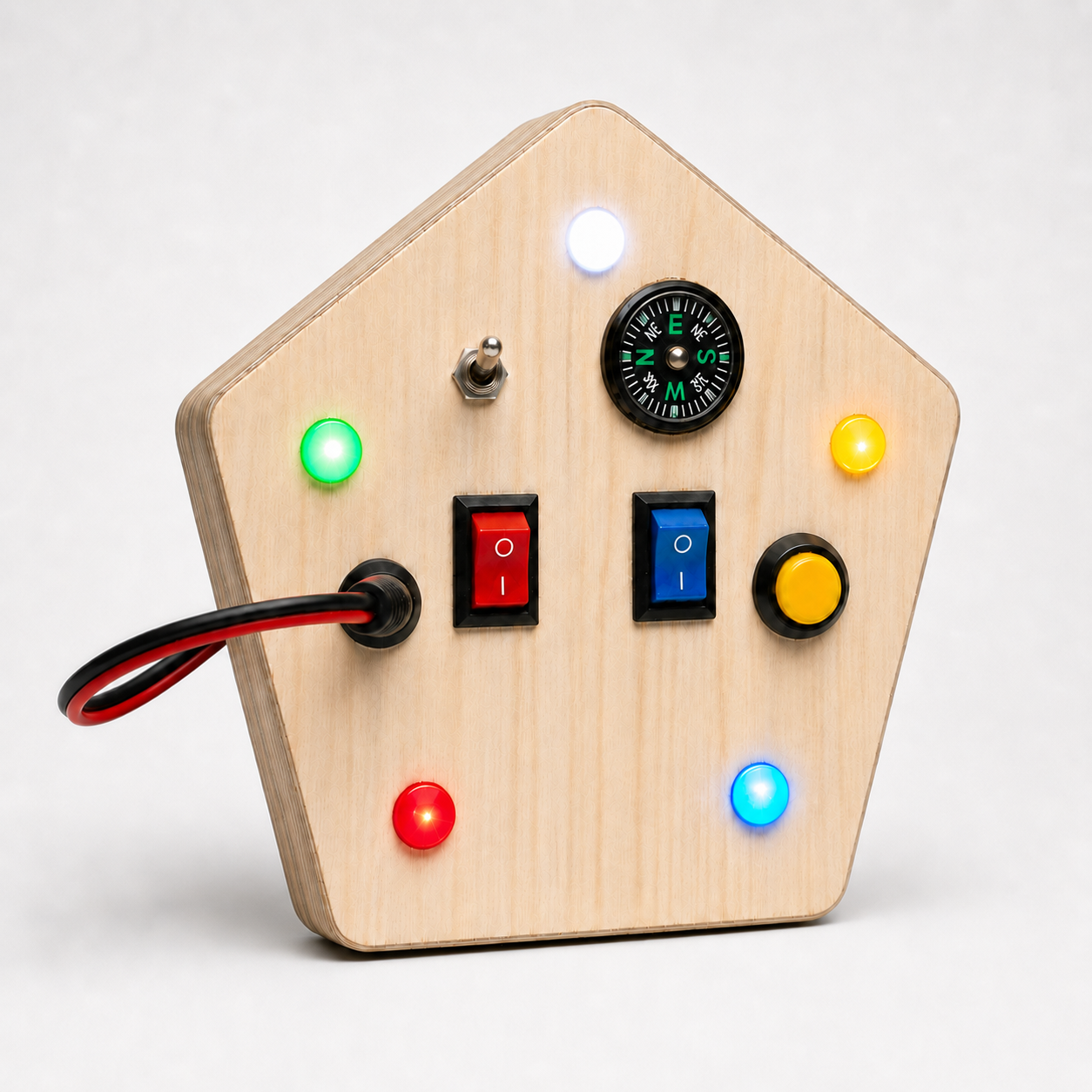 Angled view of RedMonkys Pentagon Explorer wooden busy board showing natural birch wood body, switches, LEDs, and compass